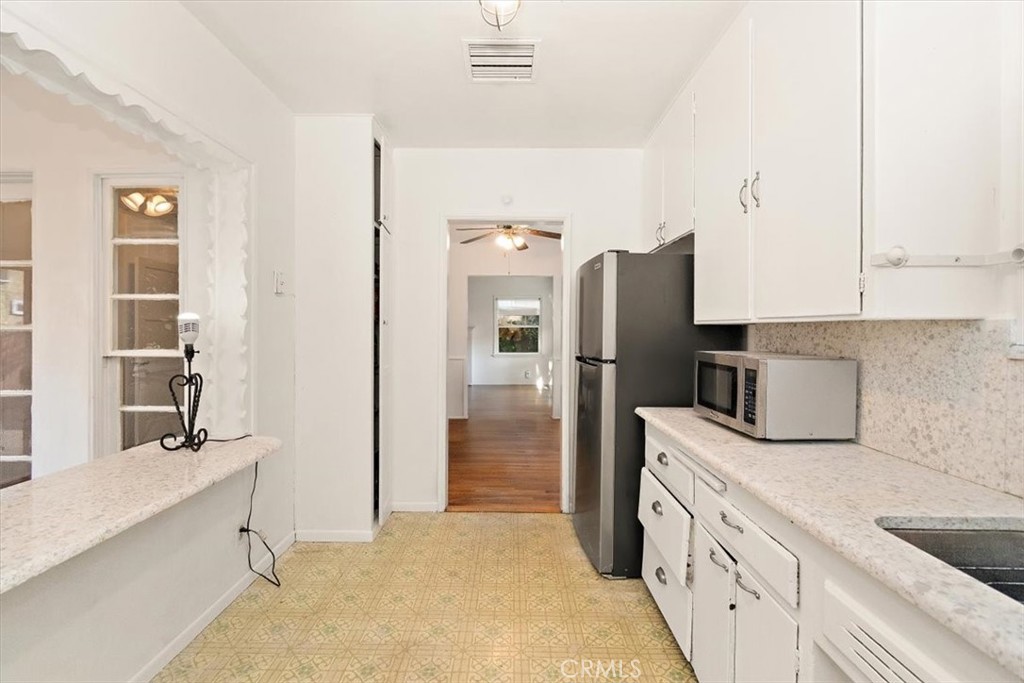14248 Friar Street Van Nuys, CA 91401 - Photo 14 of 36 a kitchen with a refrigerator and a sink