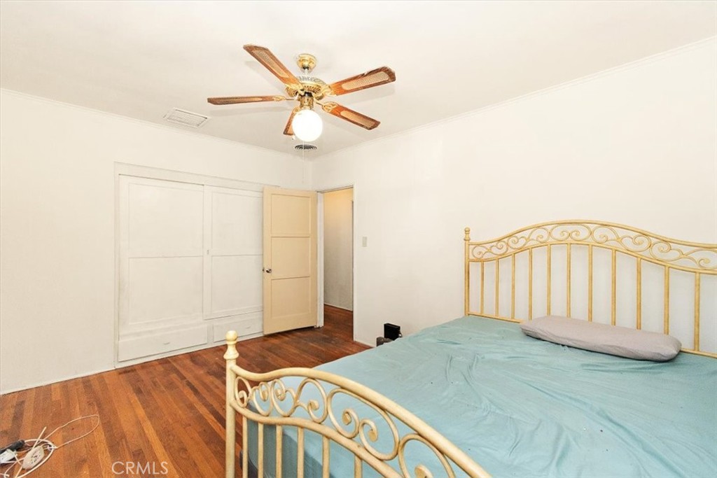 14248 Friar Street Van Nuys, CA 91401 - Photo 21 of 36 a bedroom with a bed and a chandelier