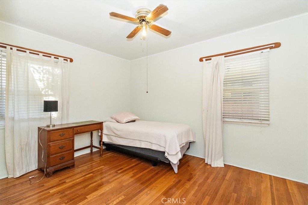 14248 Friar Street Van Nuys, CA 91401 - Photo 22 of 36 a bedroom with a bed and a chandelier