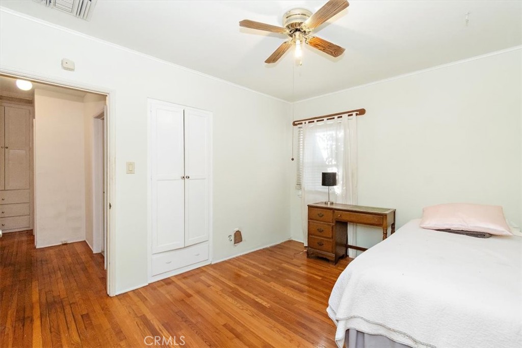 14248 Friar Street Van Nuys, CA 91401 - Photo 23 of 36 a bedroom with a bed and wooden floor