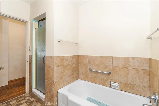 a bathroom with a bathtub and shower