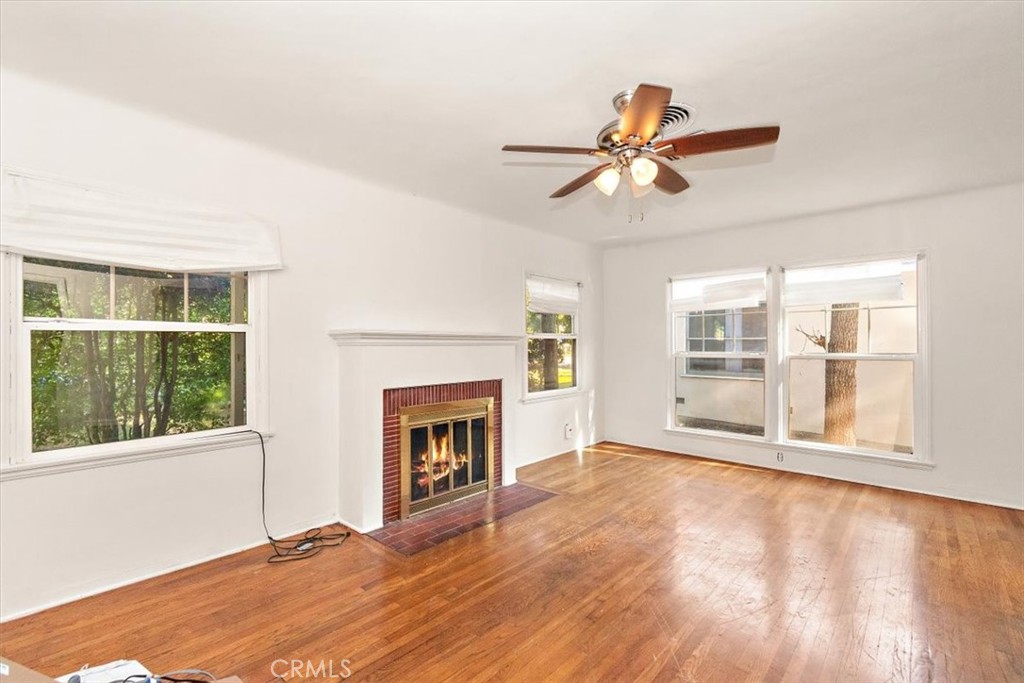 14248 Friar Street Van Nuys, CA 91401 - Photo 8 of 36 a view of empty room with wooden floor and fan