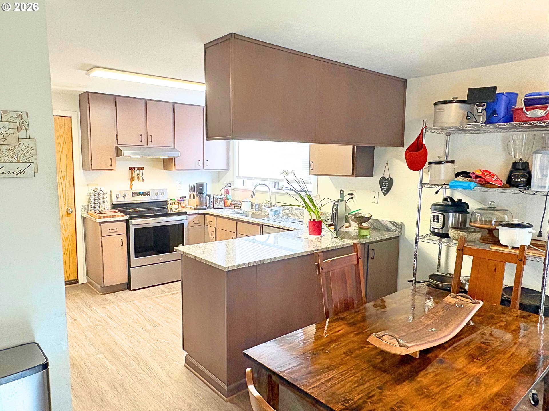 1708 Jasper Avenue Sutherlin, OR 97479 - Photo 4 of 30 a kitchen with granite countertop a sink a stove and wooden cabinets