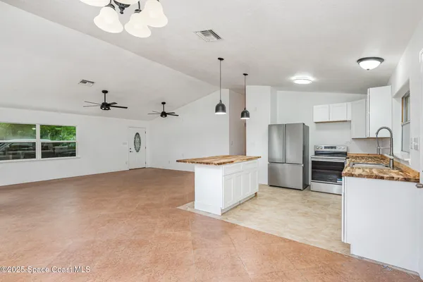 a kitchen with refrigerator a stove and a cabinets