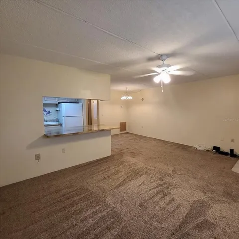 a view of a room with a ceiling fan