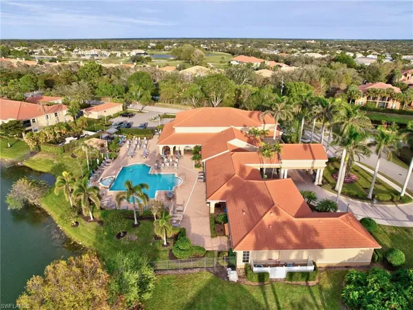 an aerial view of residential houses with outdoor space and swimming pool