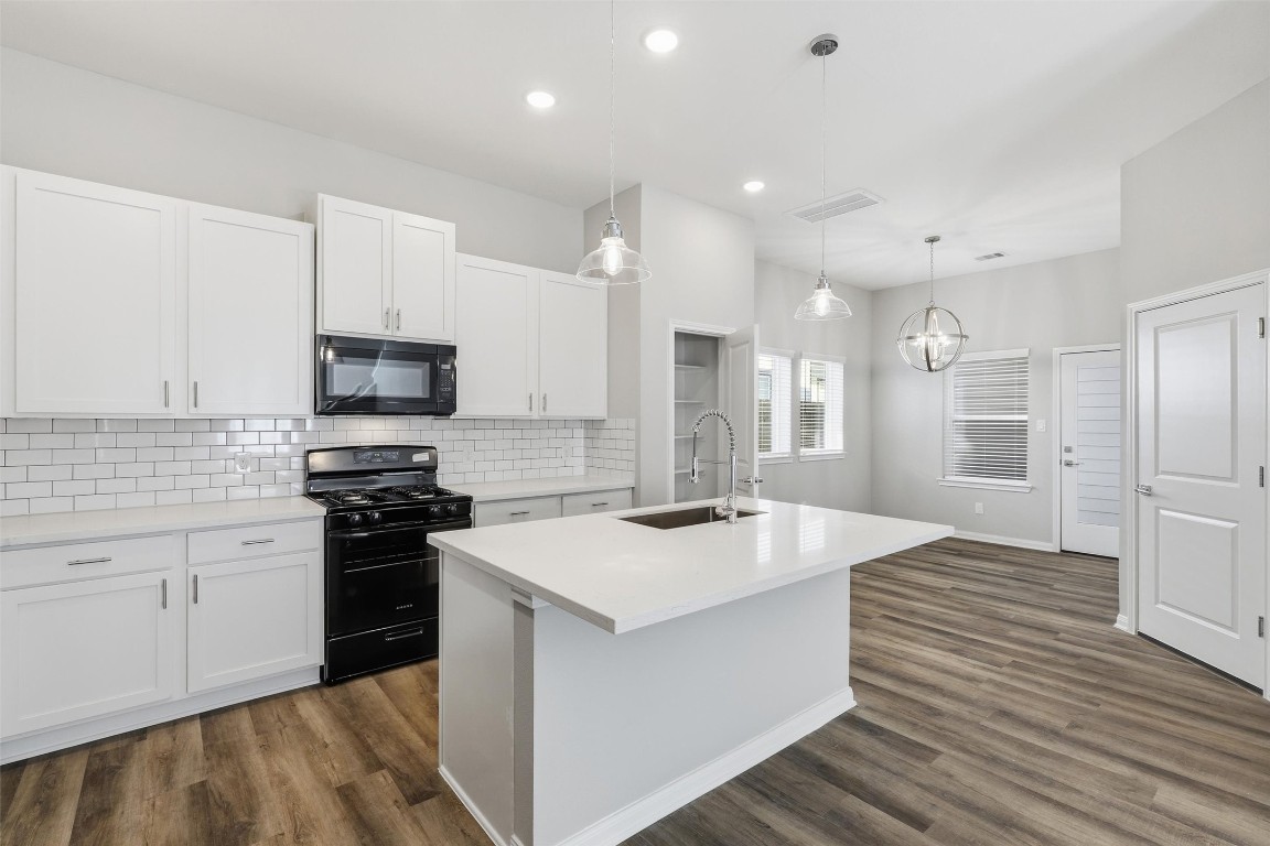 9912 Clark Road, Unit B Houston, TX 77076 - Photo 12 of 48 a large kitchen with stainless steel appliances granite countertop a stove oven a sink dishwasher and a refrigerator with wooden floor