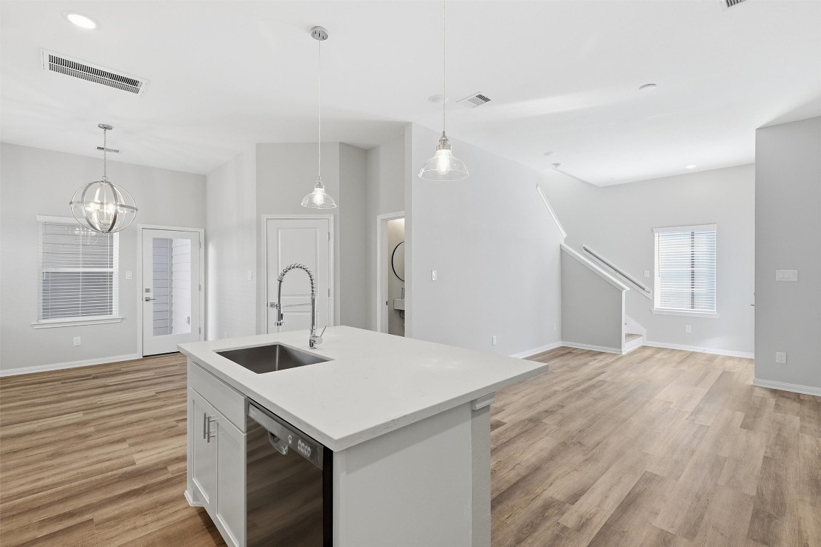 9912 Clark Road, Unit B Houston, TX 77076 - Photo 14 of 48 a view of a kitchen island a sink wooden floor and a living room