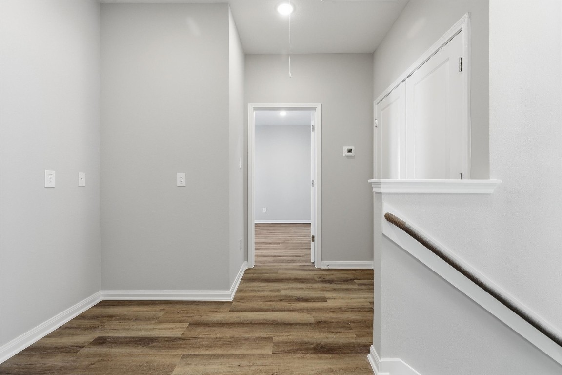 9912 Clark Road, Unit B Houston, TX 77076 - Photo 23 of 48 a view of a hallway with wooden floor and staircase