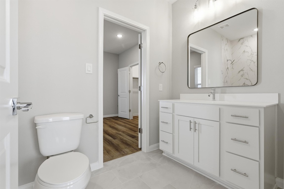 9912 Clark Road, Unit B Houston, TX 77076 - Photo 27 of 48 a bathroom with a toilet sink and mirror
