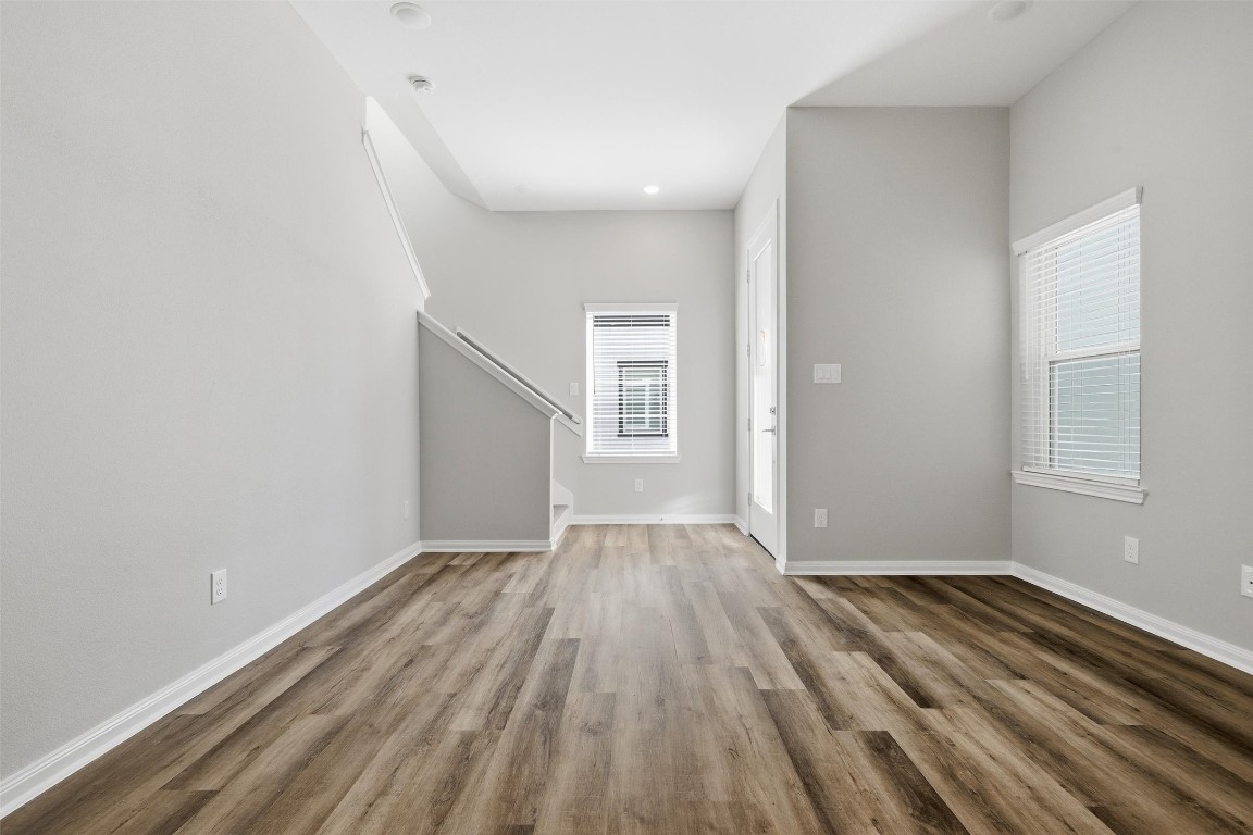 9912 Clark Road, Unit B Houston, TX 77076 - Photo 5 of 48 an empty room with wooden floor and windows