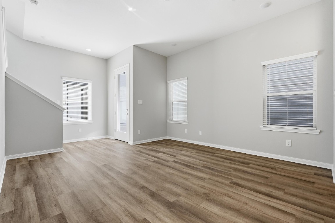 9912 Clark Road, Unit B Houston, TX 77076 - Photo 6 of 48 a view of an empty room with wooden floor and a window