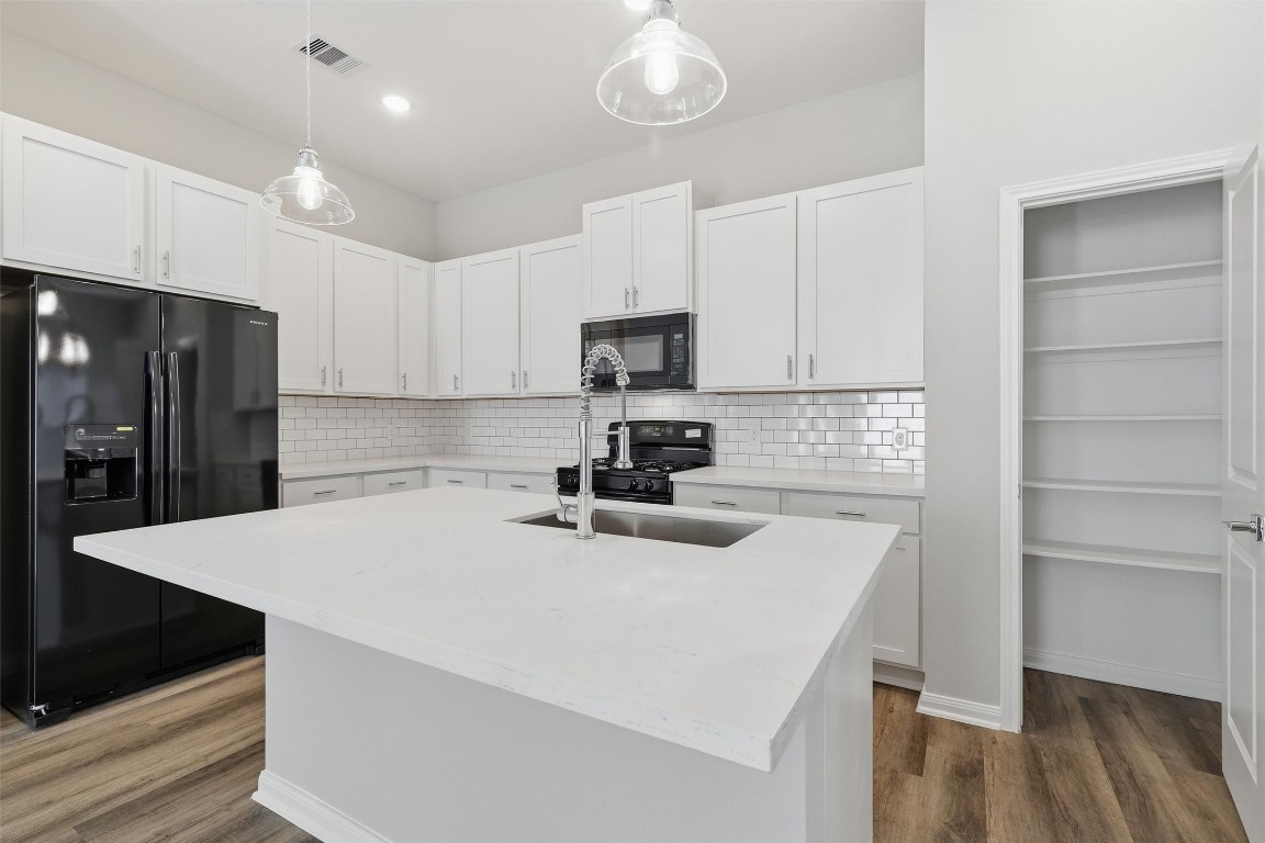 9912 Clark Road, Unit B Houston, TX 77076 - Photo 8 of 48 a kitchen with a sink a refrigerator and a stove