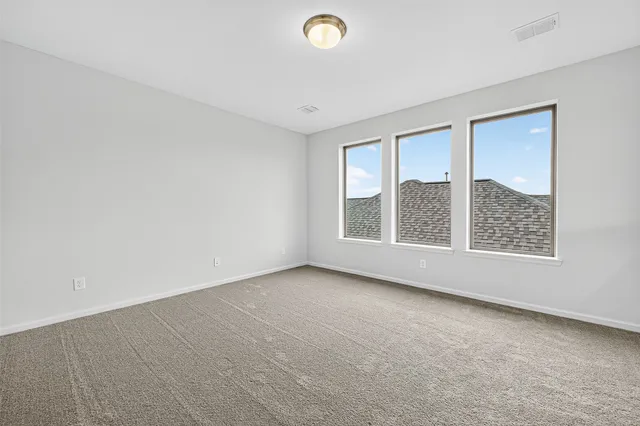 an empty room with a empty space and windows