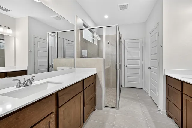 a bathroom with a sink double vanity and a mirror