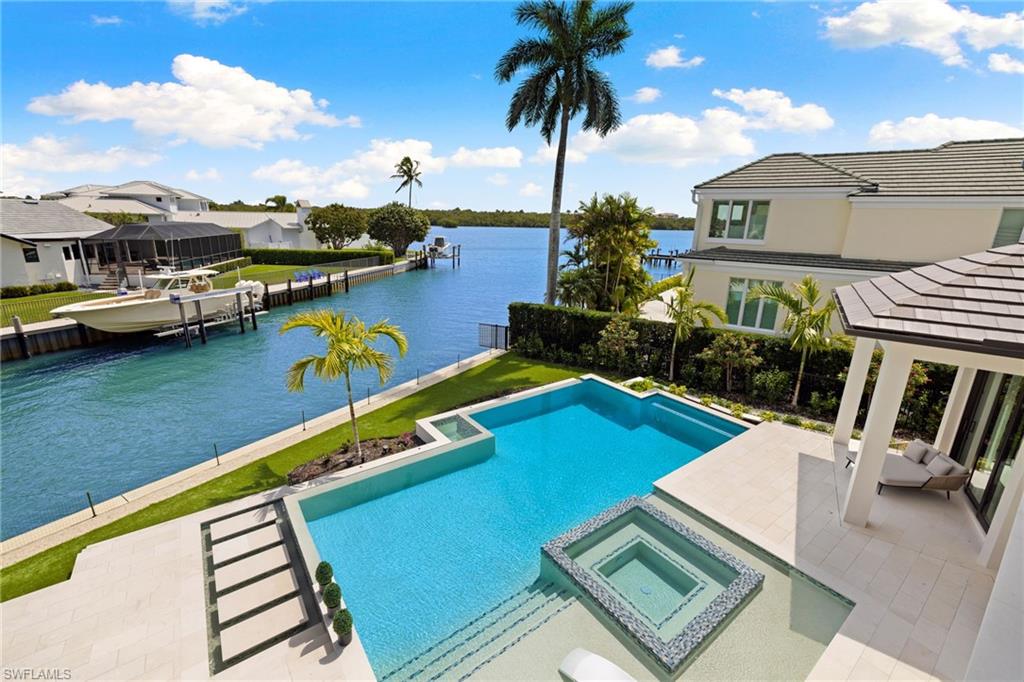 2345 Tarpon Road Naples, FL 34102 - Photo 28 of 43 Integrated pool / hot tub featuring a patio, a water view, a dock, and a gazebo