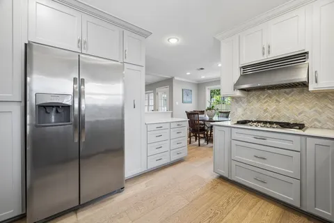 a kitchen with cabinets stainless steel appliances and counter space