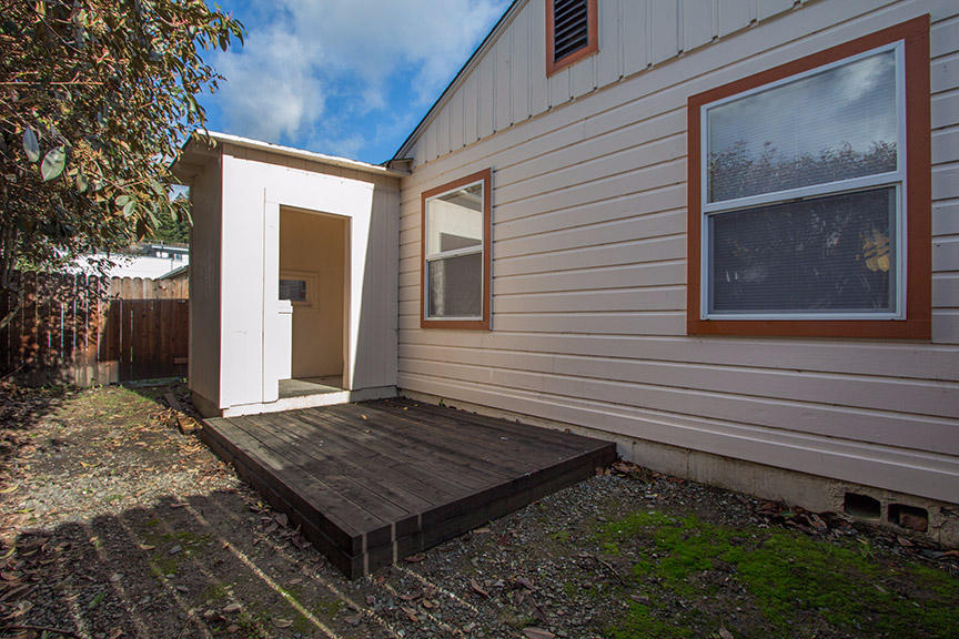 1732 Ash Street Fortuna, CA 95540 - Photo 24 of 37 a view of a small house with backyard and wooden fence