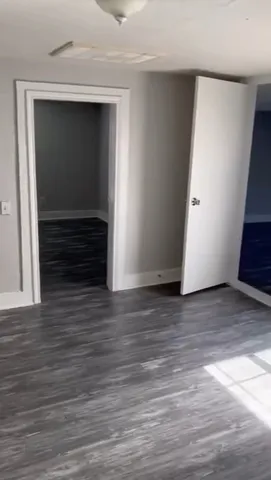 a view of room with wooden floor