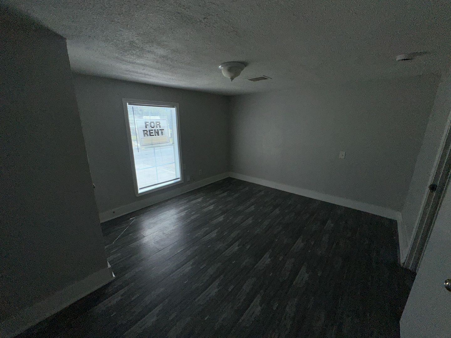 412 North 8th Street, Unit 1 Pasadena, TX 77502 - Photo 13 of 17 a view of an empty room with wooden floor and a window