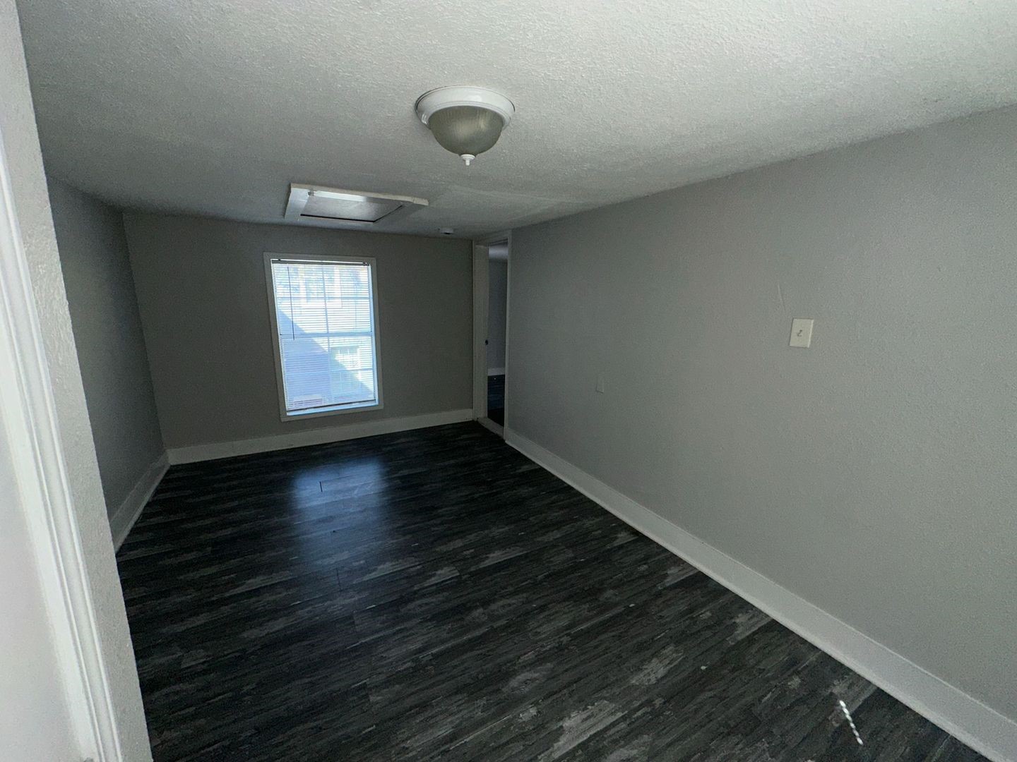 412 North 8th Street, Unit 1 Pasadena, TX 77502 - Photo 14 of 17 an empty room with wooden floor and windows