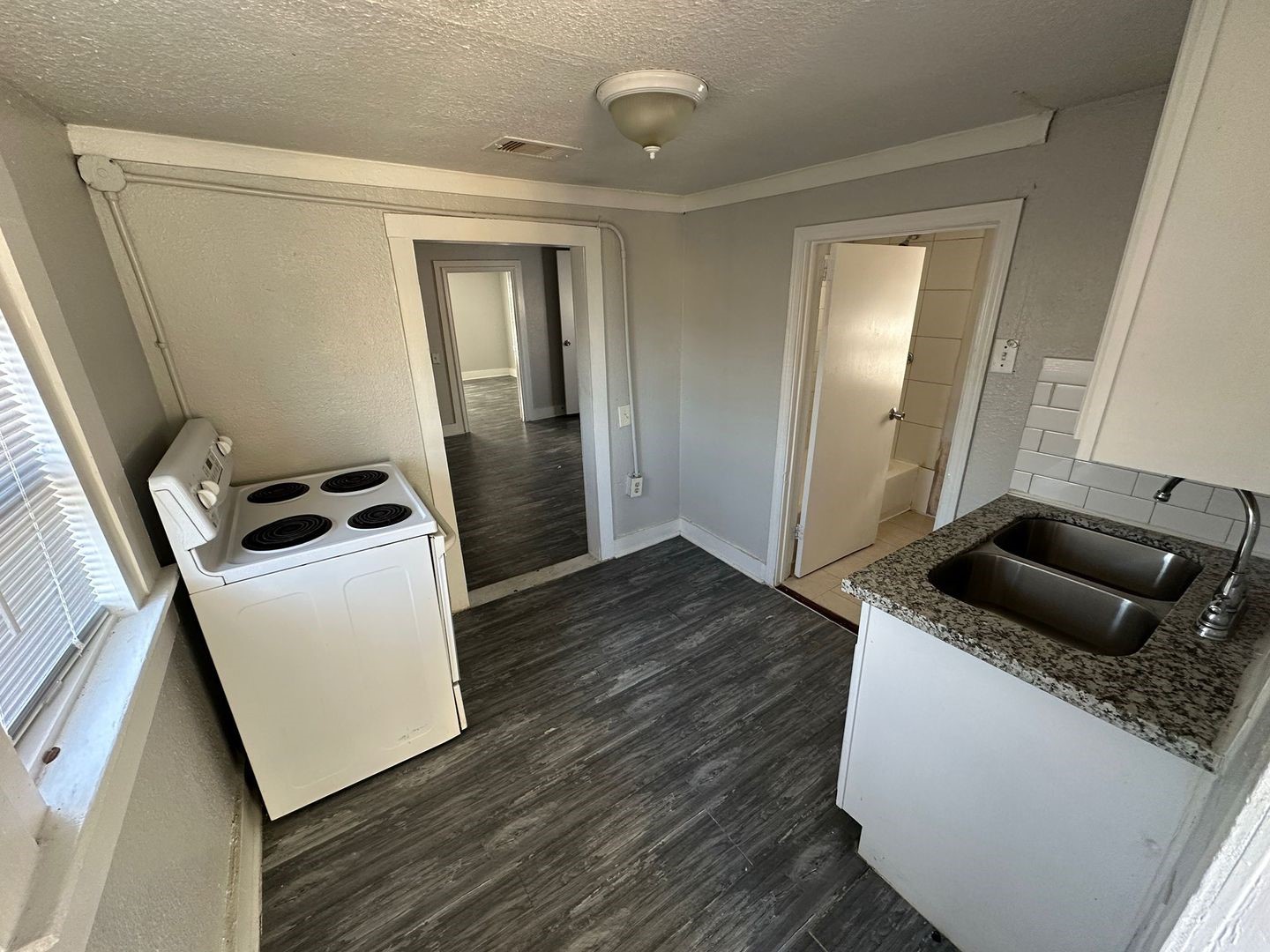 412 North 8th Street, Unit 1 Pasadena, TX 77502 - Photo 5 of 17 a kitchen with a refrigerator and wooden floor