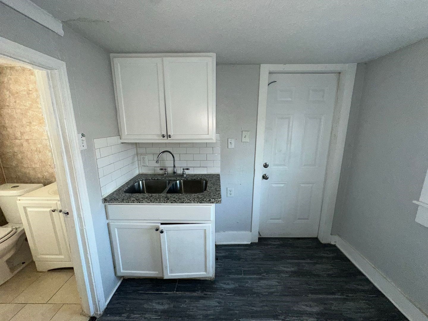 412 North 8th Street, Unit 1 Pasadena, TX 77502 - Photo 7 of 17 a kitchen with white cabinets and white appliances