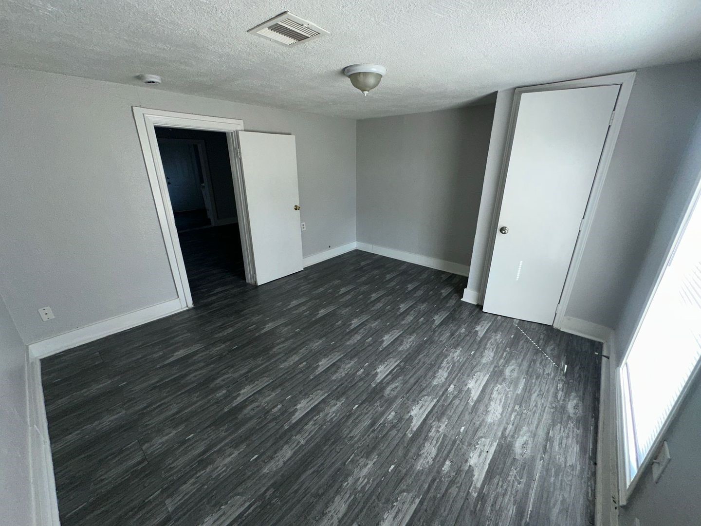 412 North 8th Street, Unit 1 Pasadena, TX 77502 - Photo 10 of 17 wooden floor in an empty room with a window