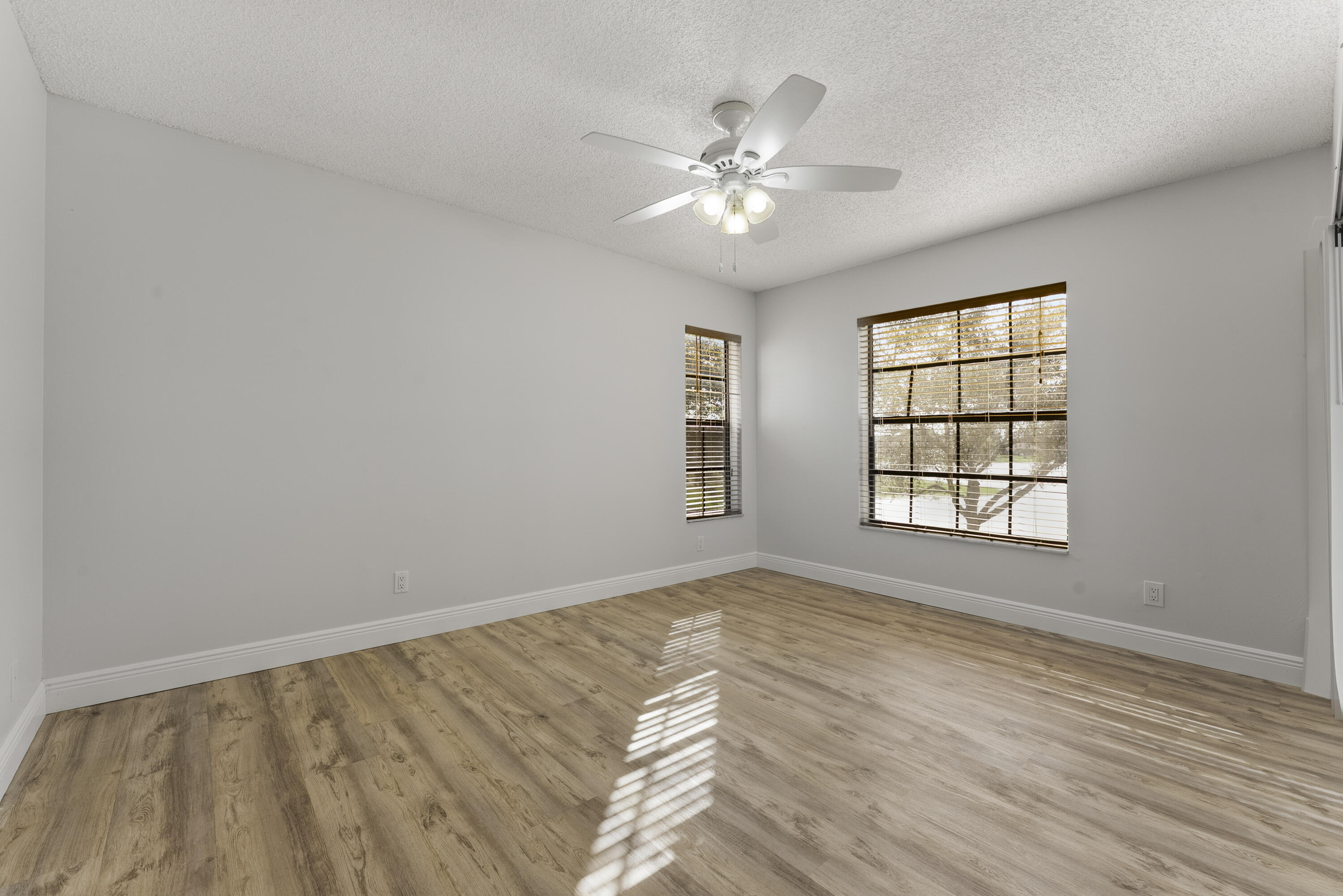 2900 Olivewood Terrace, Unit 2010 Boca Raton, FL 33431 - Photo 13 of 22 a view of an empty room with wooden floor and a window