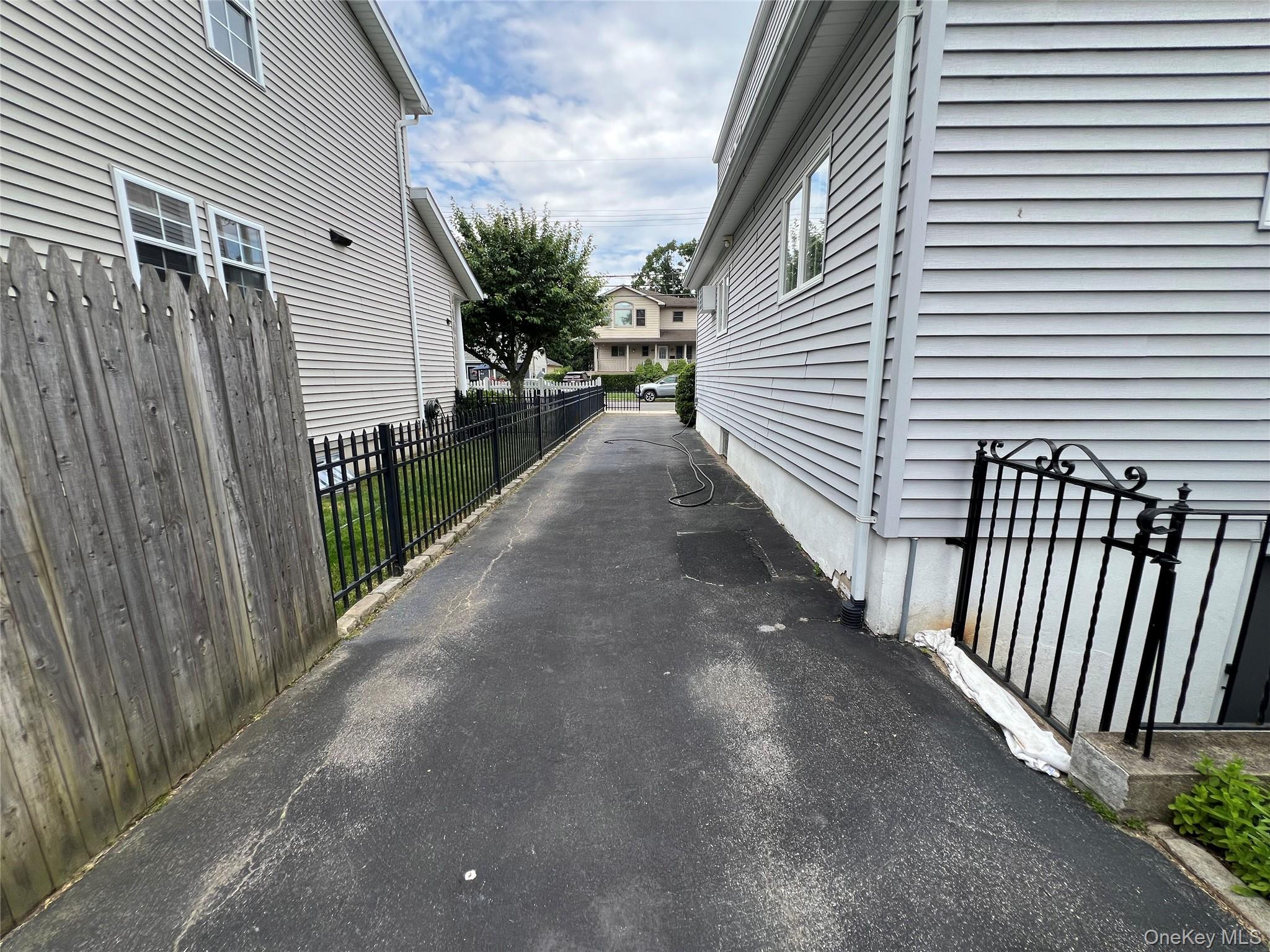 54 Edgewood Road, Unit MAIN ST Port Washington, NY 11050 - Photo 20 of 20 long driveway with enclosed gate