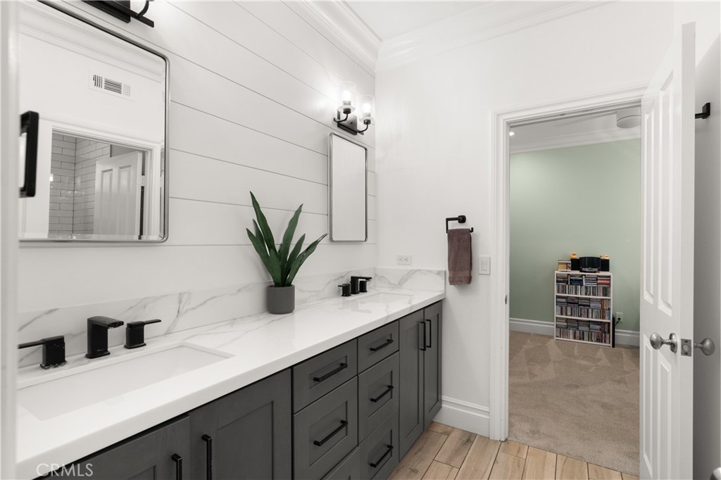6572 Beachview Drive Huntington Beach, CA 92648 - Photo 12 of 17 a bathroom with a double vanity sink a mirror and a shower