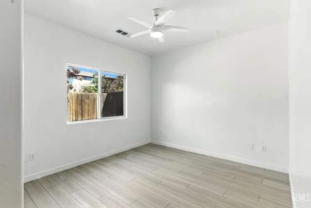 wooden floor in an empty room with a window