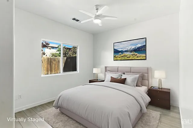 a bedroom with a bed and a painting on the wall