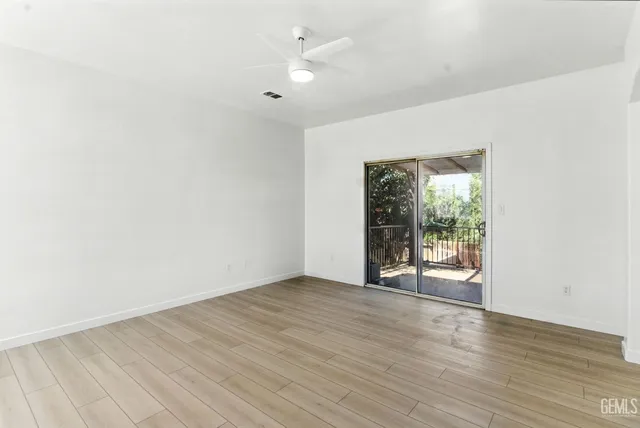 wooden floor in an empty room with a window