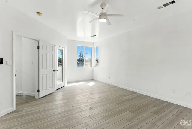 wooden floor in an empty room with a window