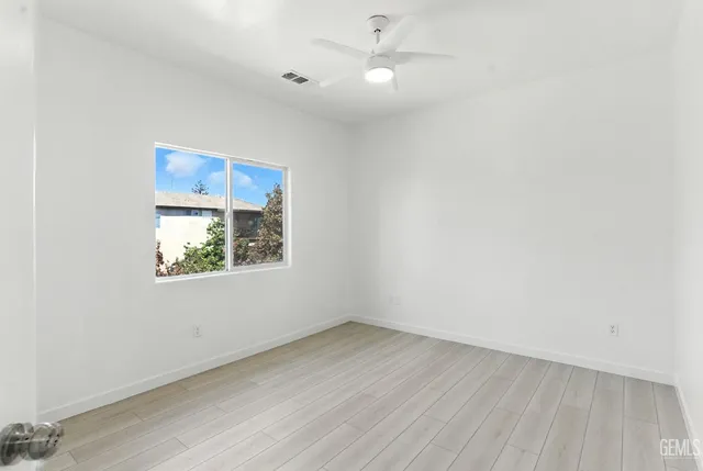 an empty room with a window and closet