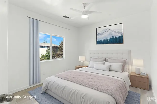 a bedroom with a large bed and a window