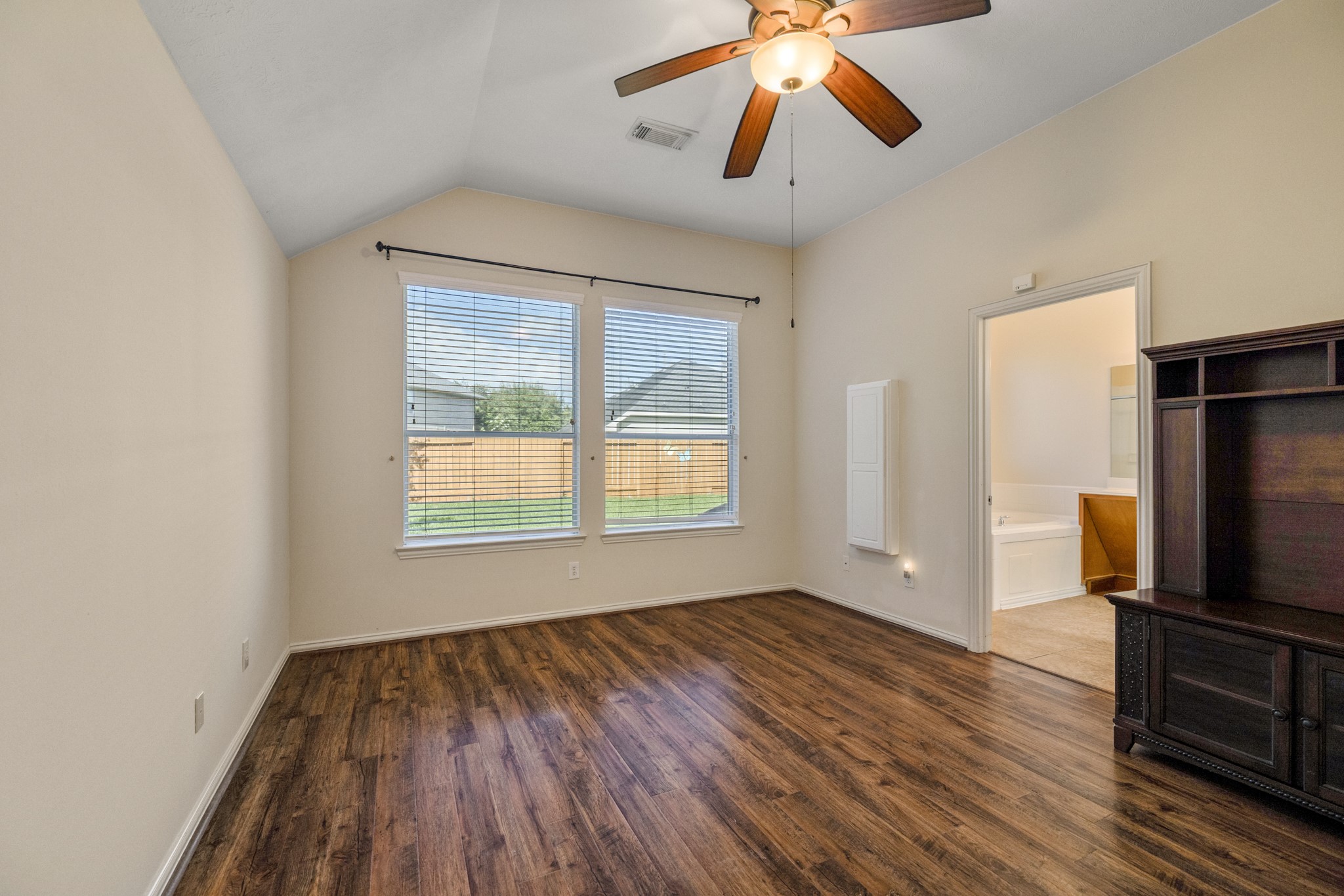 20014 Queens Oak Court Spring, TX 77379 - Photo 19 of 49 a view of a room with wooden floor a ceiling fan and windows