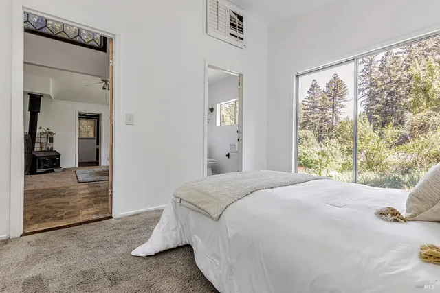 a bedroom with a bed and a large mirror