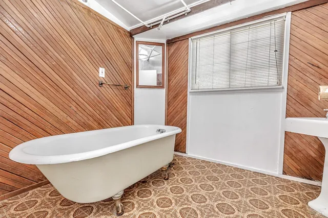 a bathroom with a bathtub and shower