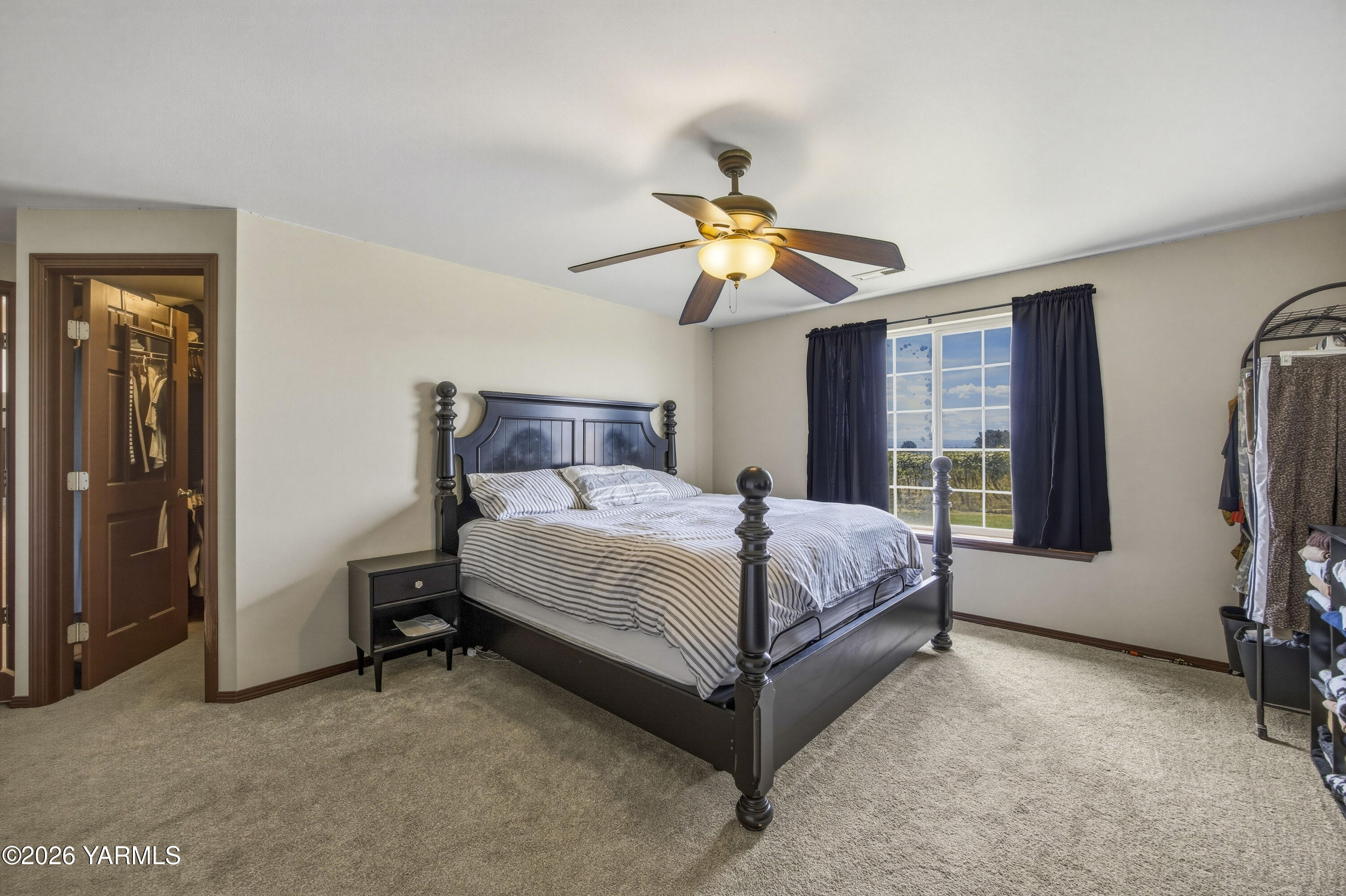 2050 Olmstead Road Grandview, WA 98930 - Photo 43 of 60 a bedroom with a bed and a chandelier