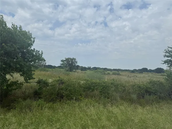 a view of a lake and green valley
