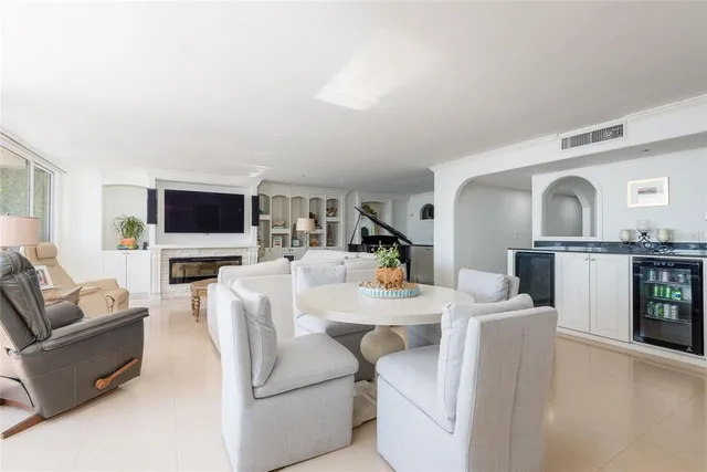 a living room with furniture a large window a flat screen tv and a floor to ceiling window