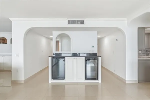a bathroom with a granite countertop toilet sink and mirror