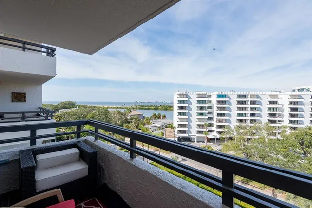 a living room with furniture a window and bookshelf