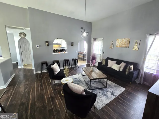 a living room with furniture and wooden floor