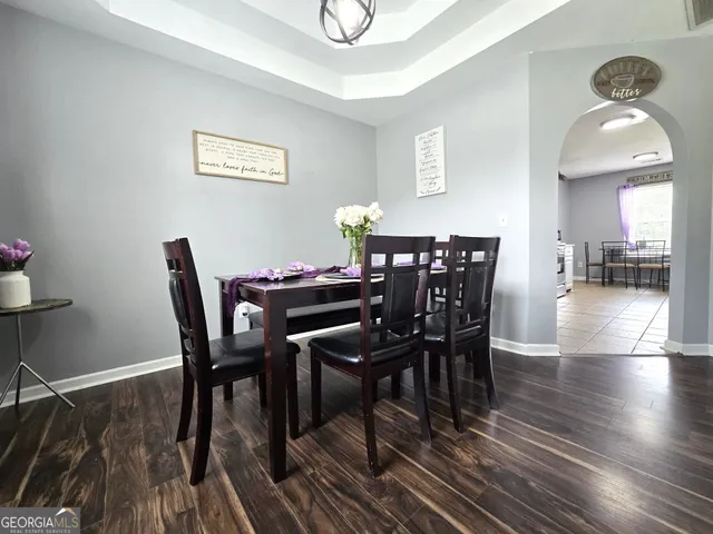 a view of a dining room with furniture and wooden floor