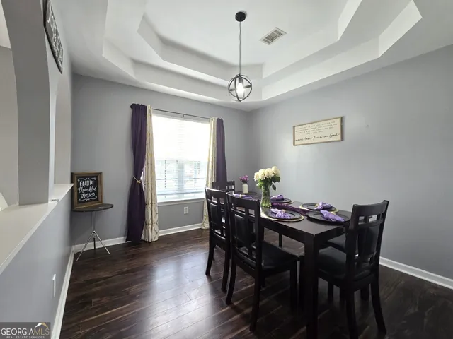 a view of a dining room with furniture window and wooden floor