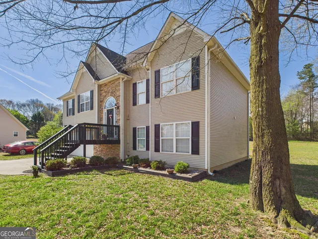 a house that has a tree in front of it