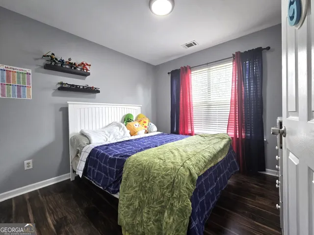 a bed sitting in a bedroom next to a window